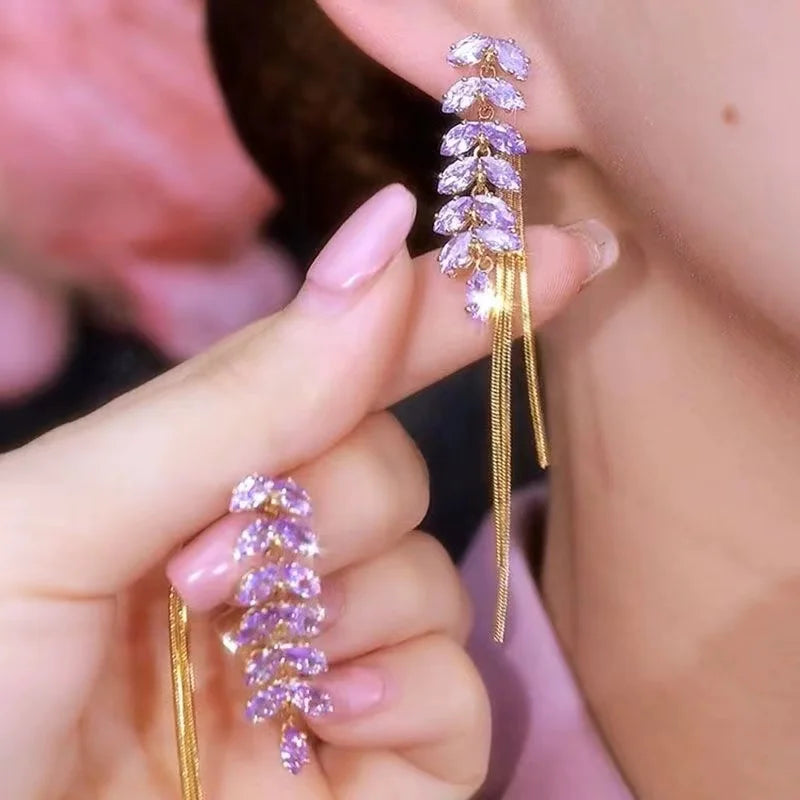 Elevate your elegance with the **Sparkling Purple Zircon Inlaid Wheat Ear Wire Long Tassel Earrings** by *Glam Sleek*. Featuring shimmering purple zircon stones inlaid in a delicate wheat ear design, these earrings exude timeless sophistication. The graceful long tassels add a touch of modern glamour, perfect for both formal occasions and stylish evenings out. Lightweight and versatile, they effortlessly enhance your look with a blend of luxury and charm. Available to USA, Canada, Australia, UK, Europe.