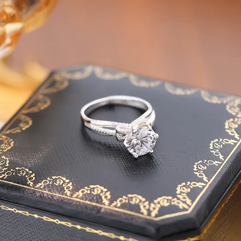 Capture every special moment with the Sparkling Bow Moissanite Ring by Glam Sleek. This radiant piece, featuring a delicately crafted bow design, is adorned with a brilliant moissanite centerpiece that rivals diamond-like sparkle and durability. Perfect for promises, engagements, weddings, or anniversaries, its timeless elegance symbolizes everlasting love and commitment. Made with premium materials, this ring shines with sophistication and is designed for the modern, stylish wearer who values both beauty a