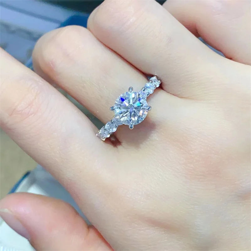 Introducing the **Glam Sleek Sparkling Moissanite Promise Ring**—a timeless symbol of love and commitment. Crafted with a brilliant moissanite gemstone, it dazzles with unmatched sparkle, resembling the beauty of a diamond at a fraction of the cost. Set in sleek, polished metal, this ring combines elegance and sophistication, perfect for celebrating your most cherished promises.