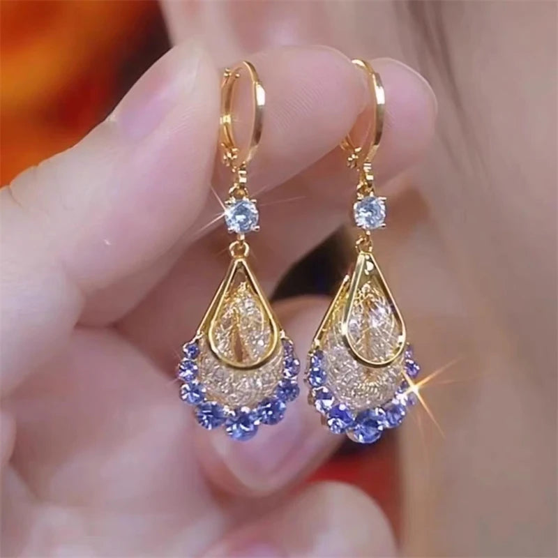 Shop shiny purple crystal tassel earrings for women featuring rhinestone water-drop details. Perfect statement jewelry for weddings, parties and special occasions.