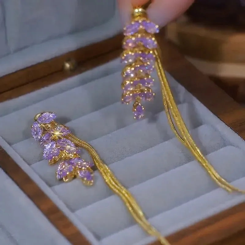 Purple Zircon Inlaid Wheat Ear Wire Long Tassel Earrings for Women add an elegant touch of sparkle to any outfit. Featuring dazzling purple zircon stones, a delicate wheat-ear design, and long tassel drops, these statement earrings are perfect for parties, weddings, dates, and special occasions. A stylish choice for women who love trendy, elegant, and glamorous jewelry.
