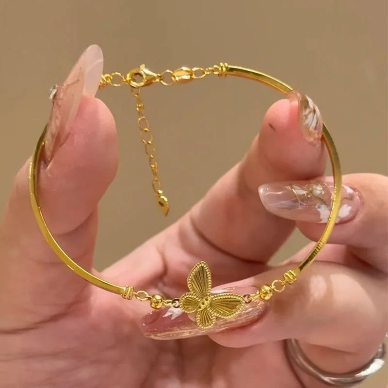 Light Luxury Shiny Zircon Golden Butterfly Bracelet for Women — an elegant gold-tone bracelet featuring sparkling zircon accents and a delicate butterfly design. Lightweight and stylish, it adds a refined touch to everyday outfits, parties, weddings, and special occasions. A beautiful choice for women who love trendy, elegant and feminine jewelry.