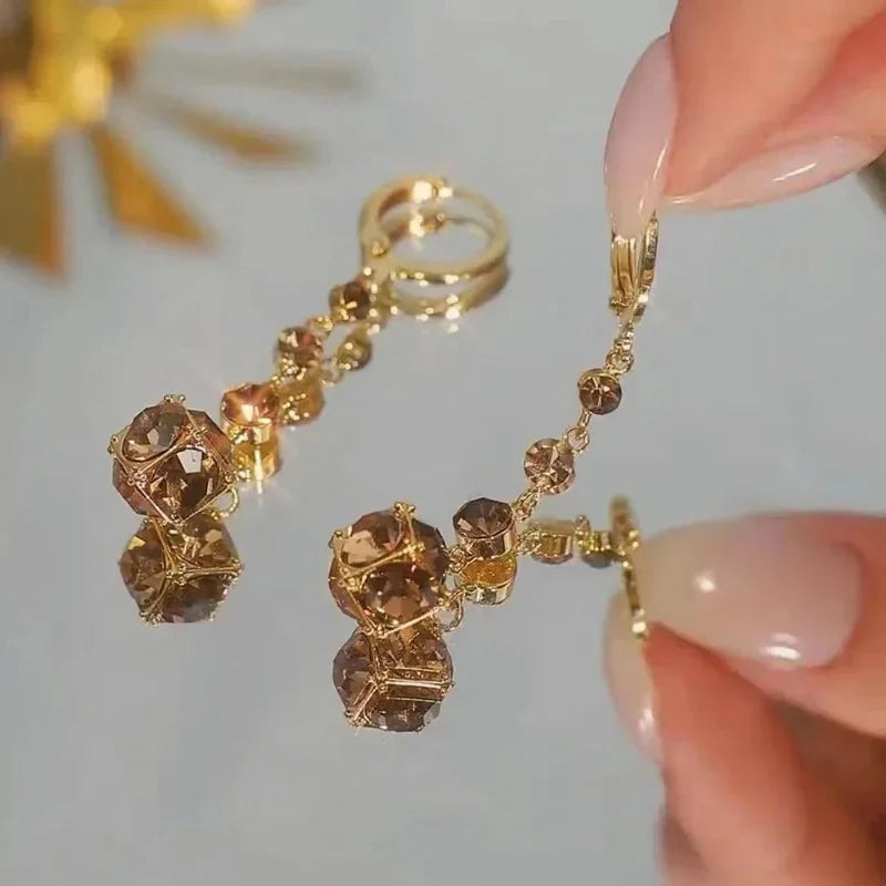 Exquisite Brown Rhinestone Ball Zircon Tassel Earrings for Women by Glam Sleek — Add effortless glamour to any look with these elegant brown rhinestone ball and zircon tassel earrings. Featuring sparkling zircon accents, a statement ball design, and flowing tassel detail, they’re perfect for weddings, parties, evenings, and special occasions. A stylish choice for women who love trendy, elegant, and statement jewelry.
