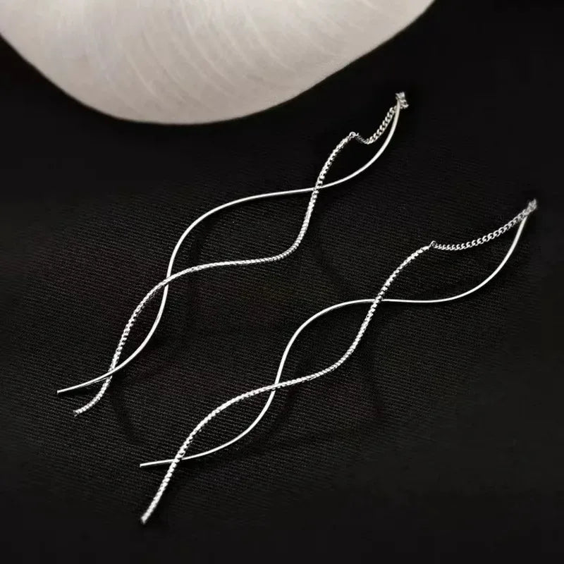 Shop minimalist long wavy fringe earrings for women at Glam Sleek. Elegant hanging earrings perfect for everyday, party, wedding and formal looks.