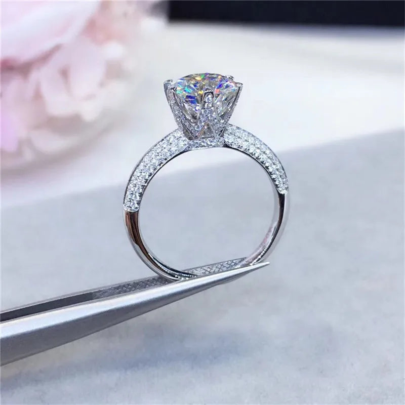Introducing the **Sparkling Crown Moissanite Ring** by Glam Sleek – a stunning symbol of love and commitment. This elegant ring features a brilliant crown-set moissanite stone, known for its dazzling sparkle and lasting durability. Perfect for a promise, engagement, wedding, or anniversary, its timeless design ensures it shines in every moment. Crafted with precision and sophistication, this ring offers luxury without compromise, making it an unforgettable piece for any occasion.