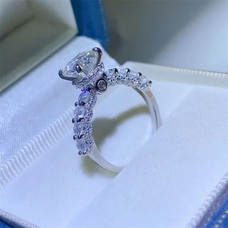 Introducing the **Glam Sleek Sparkling Moissanite Promise Ring**—a timeless symbol of love and commitment. Crafted with a brilliant moissanite gemstone, it dazzles with unmatched sparkle, resembling the beauty of a diamond at a fraction of the cost. Set in sleek, polished metal, this ring combines elegance and sophistication, perfect for celebrating your most cherished promises.