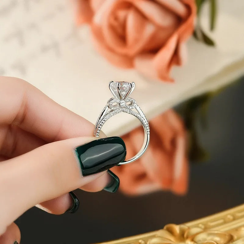 Capture every special moment with the Sparkling Bow Moissanite Ring by Glam Sleek. This radiant piece, featuring a delicately crafted bow design, is adorned with a brilliant moissanite centerpiece that rivals diamond-like sparkle and durability. Perfect for promises, engagements, weddings, or anniversaries, its timeless elegance symbolizes everlasting love and commitment. Made with premium materials, this ring shines with sophistication and is designed for the modern, stylish wearer who values both beauty a