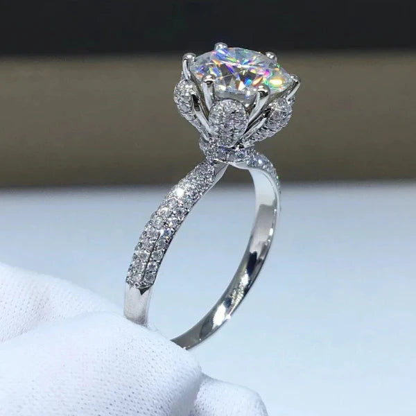 The *Sparkling Moissanite Flower Ring* by **Glam Sleek** is a stunning symbol of love and elegance. Featuring a radiant moissanite stone set in a delicate flower design, this ring captures light with breathtaking brilliance. Perfect for a promise, engagement, wedding, or anniversary, it combines timeless beauty with modern sophistication. Crafted with precision, it's a meaningful statement of forever.