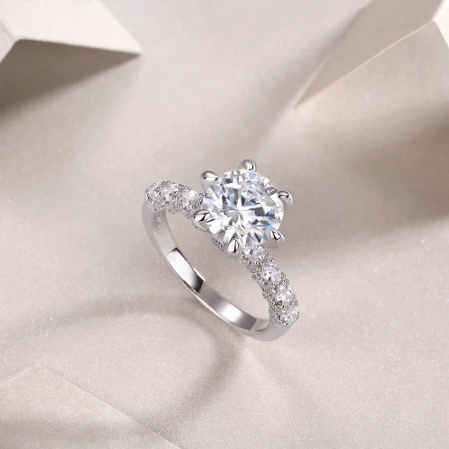 Introducing the **Glam Sleek Sparkling Round Cut Moissanite Ring**—an exquisite symbol of love and elegance. Featuring a brilliant 1-3ct real Moissanite stone, this stunning ring dazzles with unmatched fire and clarity. Perfect for promise, engagement, wedding, or anniversary, its timeless round-cut design ensures lasting beauty and sophistication. Celebrate your forever moments with the enduring brilliance of Moissanite, set in a sleek, luxurious band crafted for those who appreciate both style and sentime