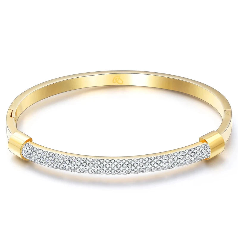 Introducing the **Shining White Crystal Bangle** by *Glam Sleek* – a stunning blend of elegance and modern sophistication. This beautifully crafted bangle features shimmering white crystals set in a sleek, minimalist design, perfect for adding a touch of glamour to any outfit. Lightweight and versatile, it's the ideal accessory for both casual and formal occasions. Elevate your style effortlessly with this sparkling statement piece.