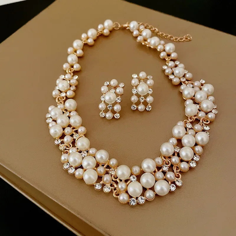 Elevate any look with Glam Sleek's Rhinestone Pearl Rectangular Earrings and Necklace Set. This chic set combines timeless pearls with shimmering rhinestones in a unique rectangular design, adding a touch of elegance to any outfit. Perfect for special occasions or adding a glam edge to everyday wear, it’s the ideal blend of classic beauty and modern style.