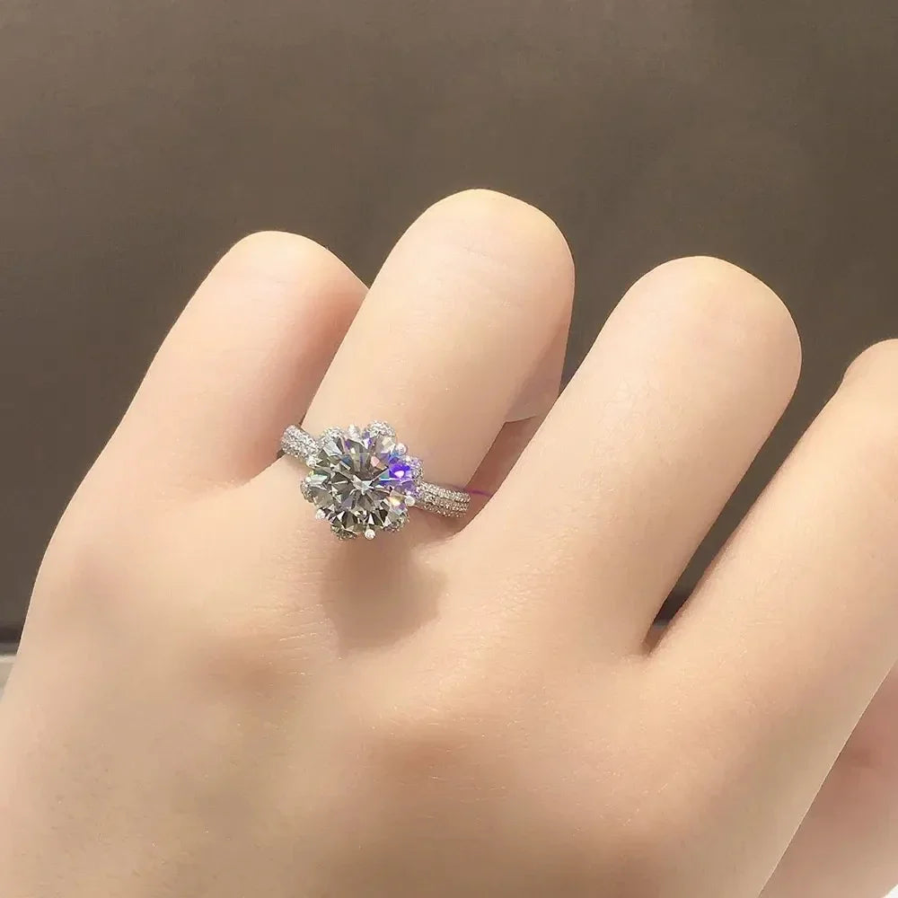The *Sparkling Moissanite Flower Ring* by **Glam Sleek** is a stunning symbol of love and elegance. Featuring a radiant moissanite stone set in a delicate flower design, this ring captures light with breathtaking brilliance. Perfect for a promise, engagement, wedding, or anniversary, it combines timeless beauty with modern sophistication. Crafted with precision, it's a meaningful statement of forever.