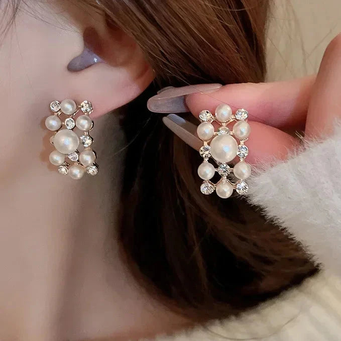 Elevate any look with Glam Sleek's Rhinestone Pearl Rectangular Earrings and Necklace Set. This chic set combines timeless pearls with shimmering rhinestones in a unique rectangular design, adding a touch of elegance to any outfit. Perfect for special occasions or adding a glam edge to everyday wear, it’s the ideal blend of classic beauty and modern style.