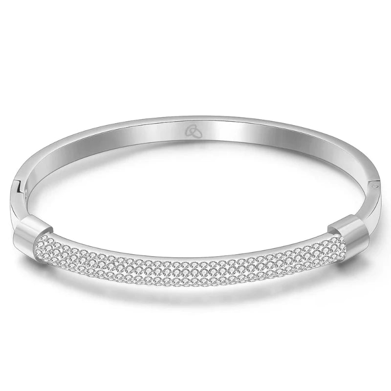 Introducing the **Shining White Crystal Bangle** by *Glam Sleek* – a stunning blend of elegance and modern sophistication. This beautifully crafted bangle features shimmering white crystals set in a sleek, minimalist design, perfect for adding a touch of glamour to any outfit. Lightweight and versatile, it's the ideal accessory for both casual and formal occasions. Elevate your style effortlessly with this sparkling statement piece.