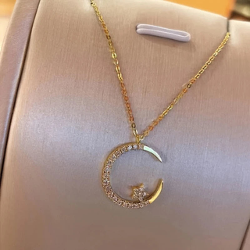 The *Shining Inlaid Zirconia Moon Star Pendant* by Glam Sleek is a celestial-inspired piece that adds a touch of elegance to any outfit. Featuring a delicate moon and star design, this pendant is inlaid with shimmering zirconia stones, capturing the magic of the night sky. Perfect for everyday wear or special occasions, it blends sophistication with a modern, minimalist charm. Ideal as a gift or a treat for yourself, this pendant effortlessly elevates your style with its radiant sparkle.