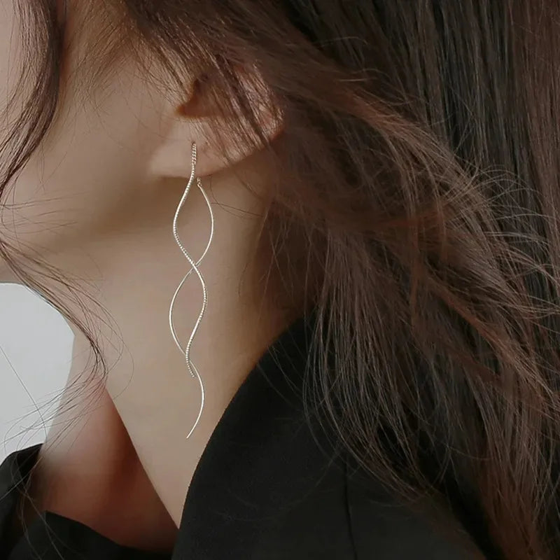 Shop minimalist long wavy fringe earrings for women at Glam Sleek. Elegant hanging earrings perfect for everyday, party, wedding and formal looks.