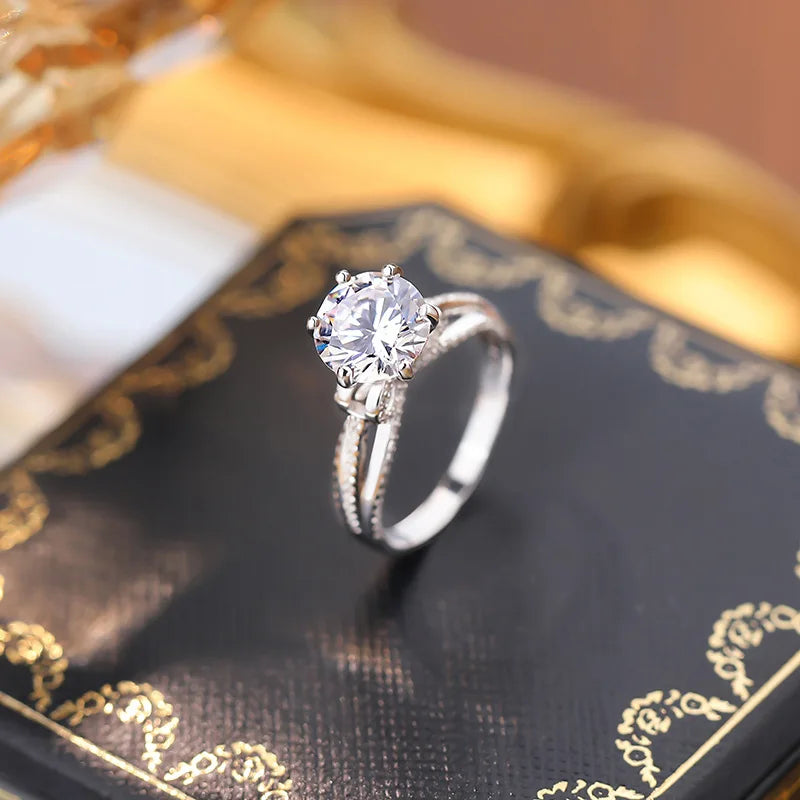 Capture every special moment with the Sparkling Bow Moissanite Ring by Glam Sleek. This radiant piece, featuring a delicately crafted bow design, is adorned with a brilliant moissanite centerpiece that rivals diamond-like sparkle and durability. Perfect for promises, engagements, weddings, or anniversaries, its timeless elegance symbolizes everlasting love and commitment. Made with premium materials, this ring shines with sophistication and is designed for the modern, stylish wearer who values both beauty a