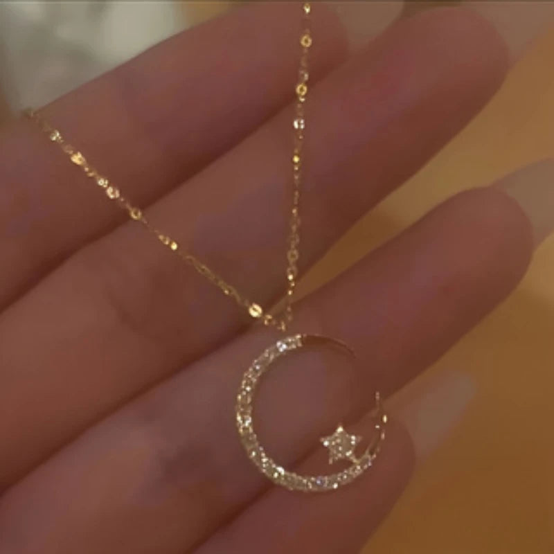 The *Shining Inlaid Zirconia Moon Star Pendant* by Glam Sleek is a celestial-inspired piece that adds a touch of elegance to any outfit. Featuring a delicate moon and star design, this pendant is inlaid with shimmering zirconia stones, capturing the magic of the night sky. Perfect for everyday wear or special occasions, it blends sophistication with a modern, minimalist charm. Ideal as a gift or a treat for yourself, this pendant effortlessly elevates your style with its radiant sparkle.