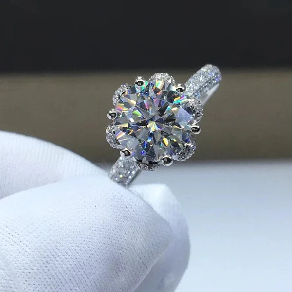 The *Sparkling Moissanite Flower Ring* by **Glam Sleek** is a stunning symbol of love and elegance. Featuring a radiant moissanite stone set in a delicate flower design, this ring captures light with breathtaking brilliance. Perfect for a promise, engagement, wedding, or anniversary, it combines timeless beauty with modern sophistication. Crafted with precision, it's a meaningful statement of forever.